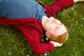 Picture of young beautiful blond man laying on green grass among Royalty Free Stock Photo