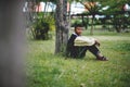 young boy sitting sadly alone in the forest Depression concept Royalty Free Stock Photo