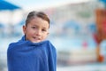 Picture of young boy in towel after playing in outdoor aqua park Royalty Free Stock Photo