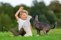 Young boy plays with two terrier hybrid dogs outdoors Royalty Free Stock Photo