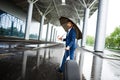 Picture of young businessman holding suitcase and umbrella walking at rainy station Royalty Free Stock Photo