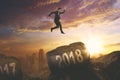 Young businessman jumping toward numbers 2018 Royalty Free Stock Photo