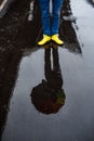 Picture of young businessman's yellow shoes in rainy street