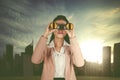 Young businesswoman looking through binoculars Royalty Free Stock Photo