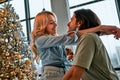 Picture of young couple hugging in Christmas time. Side view. Close up view Royalty Free Stock Photo