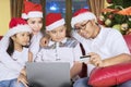 Young family shopping online at Christmas time Royalty Free Stock Photo