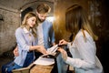 Picture of young loving couple and female receptionist at counter in hotel. Young couple receiving tourist information