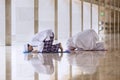 Young man doing prays with his wife in the mosque Royalty Free Stock Photo