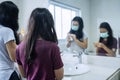 Mother and her child washing hands with soap