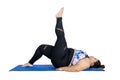 Obese woman lifting her leg during yoga exercises