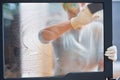 Picture of young woman cleaning fireplace glass doors