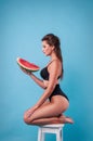 Picture of young woman holding a big slice watermelon in the studio Royalty Free Stock Photo
