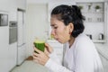 Nauseous woman drinking healthy juice