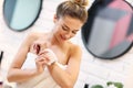 Young woman shaving armpits in bathroom Royalty Free Stock Photo