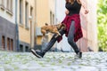 Young woman lets her small dog jumping over the leg