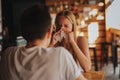 Picture from a young woman with handkerchief. Sick girl isolated has runny nose. Female model makes a cure for the Royalty Free Stock Photo