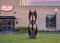 Abstract metal sculpture in front of the historic Vandergriff Office Building in Arlington, Texas.