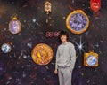 Amerasian teenage boy posing in front of a wall of clocks at Wonderland Dreams in New York City.