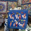 Artisan showing a piece of his work in his shop on the Street of the Tentmakers in Cairo, Egypt.