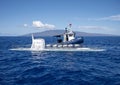 Atlantis IV submarine submerging, and submarine support vessel `Roxie` in the Pacific Ocean off the Island of Maui in Hawaii.