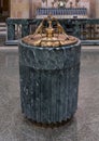 Baptismal font topped by bronze grouping of two peacocks drinking from a vase Christ the King Catholic Church in Dallas, Texas.