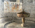 Baptismal and fresco in the Church of Santa Maria del Tiglio in Gravedona on Lake Como. Royalty Free Stock Photo