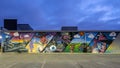 Blue hour photo of a mural featuring a mashup of Dallas city life and Texas on Sam`s Club Now in Dallas, Texas.