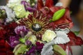 Close up of a bridal jeweled color flower bouquet with bride and groom wedding rings nestled on a flower Royalty Free Stock Photo