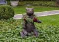 Small bronze bear with human face in a yard in Dallas, Texas