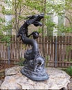 Bronze Chinese sculpture of a dragon holding a pearl in his claw in Dragon Park in Dallas, Texas.