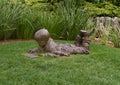 Bronze sculpture of a boy with an etch a sketch by Gary Price at the Dallas Arboretum and Botanical Garden Royalty Free Stock Photo