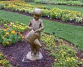 Bronze sculpture of a boy with a watering can and grasshopper by Gary Price at the Dallas Arboretum and Botanical Garden Royalty Free Stock Photo