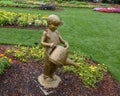 Bronze sculpture of a boy with a watering can and grasshopper by Gary Price at the Dallas Arboretum and Botanical Garden Royalty Free Stock Photo