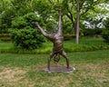 Bronze sculpture of a child doing a cartwheel by Gary Price at the Dallas Arboretum and Botanical Garden