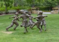 Bronze sculpture of children holding hands running in a circle by Gary Price at the Dallas Arboretum and Botanical Garden