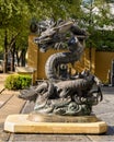 Dragon sculpture clutching a ball in it`s claw foot, located outside a hotel in Dallas, Texas.