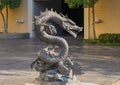 Dragon sculpture clutching a ball in it`s claw foot, located outside a hotel in Dallas, Texas.