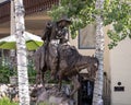 Bronze sculpture of an unarmed man on a horse with a lariat in Vail, Colorado.