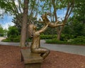 Bronze sculpture of woman holding up a happy child by Gary Price at the Dallas Arboretum and Botanical Garden