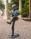 Bronze sculpture of a young baseball pitcher in The Village at Sports Center in Arlington, Texas.