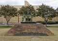 Bronze statue of two men working on a hand drilling rig on the campus of Tulsa University.