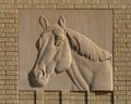 Carved stone horse head relief on the outside brick wall of the Will Rogers Equestrian Center in Fort Worth, Texas. Royalty Free Stock Photo