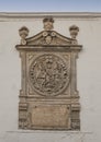 Carved stone relief above the Postigo del Aceite in Seville, Andalusia, Spain.