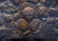 Carved stone relief of a woman above fireplace inside the Volcano House in Hawaii.