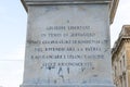 Closeup of writing on a monument with statue of Giuseppe Libertini, Lecce, Italy