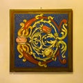 Colorful, abstract, framed painting on the wall of an Italian restaurant in Bologna, Italy.
