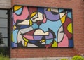 Colorful abstract mural by unidentified artist on outside wall of a building in Dallas, Texas.