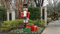 Nutcracker standing guard protecting a house in Dallas, Texas, with gifts at his feet.