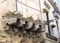 Old crumbling baroque balcony with planters, Lecce Italy