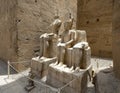 Deteriorating statue of the god Amun-Re and his wife Mut and a seated king just before the Colonnade Hall in Luxor Temple, Egypt. Royalty Free Stock Photo